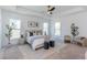 Spacious main bedroom featuring a tray ceiling, stylish décor, and bright windows at 3395 Lee St, East Point, GA 30344