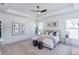 Main bedroom with a ceiling fan, windows, and decor at 3395 Lee St, East Point, GA 30344