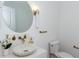 Elegant powder room showcasing a marble sink, brass fixtures, and contemporary design elements at 3395 Lee St, East Point, GA 30344