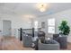 Upstairs sitting area with four chairs, modern décor, and windows with views at 3395 Lee St, East Point, GA 30344