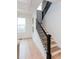 Close-up view of the staircase featuring wooden steps, and a decorative metal railing at 3395 Lee St, East Point, GA 30344