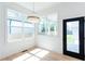 Bright sunroom with natural light, large windows and a black paneled door leading to outdoor living space at 3395 Lee St, East Point, GA 30344
