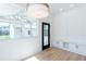 Bright sunroom with large windows, storage cabinets and a black paneled door leading to outdoor living space at 3395 Lee St, East Point, GA 30344