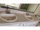 Bathroom featuring double sinks with chrome fixtures, vanity, and mirror at 75 Doves Nest, Covington, GA 30016
