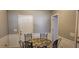 Cozy breakfast nook featuring white wainscoting, a round table, and seating for four at 75 Doves Nest, Covington, GA 30016