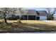 Charming one-story home with blooming tree, well-maintained lawn, and attached two-car garage at 75 Doves Nest, Covington, GA 30016