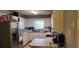 Functional kitchen with stainless steel refrigerator and appliances, white cabinets, and laminate countertop at 75 Doves Nest, Covington, GA 30016