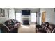 Comfortable living room featuring plush seating, fireplace, and windows providing natural light at 75 Doves Nest, Covington, GA 30016