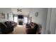 Spacious living room with plush sofas, fireplace, and ample natural light from large windows at 75 Doves Nest, Covington, GA 30016