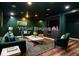 Basement living room with dark green walls, recessed lighting, and a stylish staging at 970 Winding Creek Trl, Atlanta, GA 30328