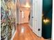 Bright hallway with hardwood floors, decorative wallpaper, and view of front door at 970 Winding Creek Trl, Atlanta, GA 30328