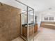 Modern bathroom featuring glass-enclosed shower, dual vanities, and soaking tub by bright window at 232 Hunt Ne St, Marietta, GA 30060