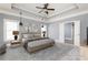 Spacious staged bedroom with trey ceilings and a ceiling fan at 232 Hunt Ne St, Marietta, GA 30060