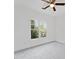 Clean bedroom with neutral carpet, a ceiling fan, and large window, perfect for relaxation at 232 Hunt Ne St, Marietta, GA 30060