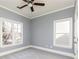 Bedroom featuring carpet flooring, two windows, and neutral-colored walls at 232 Hunt Ne St, Marietta, GA 30060