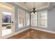 Charming dining room with large windows, hardwood floors, and modern chandelier at 232 Hunt Ne St, Marietta, GA 30060