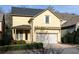 Charming yellow two-story home with attached garage, pergola, and well-maintained landscaping at 232 Hunt Ne St, Marietta, GA 30060