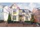 Charming two-story home with yellow siding, black trim and landscaped front yard and blooming trees at 232 Hunt Ne St, Marietta, GA 30060