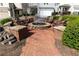 Community fire pit area with seating on a brick patio surrounded by landscaping at 232 Hunt Ne St, Marietta, GA 30060