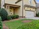 Charming home features a well-maintained lawn, a covered porch, and an attached garage at 232 Hunt Ne St, Marietta, GA 30060
