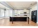 Open kitchen with center island, stone countertops, stainless steel appliances, and eat-in area at 232 Hunt Ne St, Marietta, GA 30060