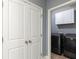 Modern laundry room featuring black appliances and storage adjacent to folding doors at 232 Hunt Ne St, Marietta, GA 30060