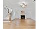 Living room featuring a fireplace, staircase, hardwood floors, and windows overlooking the exterior at 232 Hunt Ne St, Marietta, GA 30060