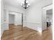 Spacious living room features hardwood floors, classic wainscoting, and elegant chandelier at 232 Hunt Ne St, Marietta, GA 30060