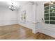 Bright living room boasts hardwood floors, elegant chandelier, and classic wainscoting detail at 232 Hunt Ne St, Marietta, GA 30060