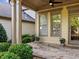 Inviting covered patio with stone flooring, beige pillars, and lush landscaping at 232 Hunt Ne St, Marietta, GA 30060