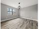 Neutral room with modern light fixture, a window, and new floors at 7012 Winter Woods Ct, Morrow, GA 30260