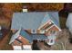 Aerial view of a brick home with a gray roof, bay window, and well-maintained landscaping at 912 Tanners Point Dr, Lawrenceville, GA 30044