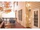 Spacious back deck with a table and chairs, grill, firewood and entrance into the home at 912 Tanners Point Dr, Lawrenceville, GA 30044