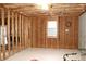 Unfinished basement featuring framing, insulation, and a window providing natural light at 912 Tanners Point Dr, Lawrenceville, GA 30044