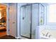 Bathroom with glass-enclosed shower, bathtub, white subway tiles and neutral paint at 912 Tanners Point Dr, Lawrenceville, GA 30044