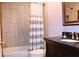 Bathroom featuring a shower/tub combo, decorative shower curtain, and dark wood vanity at 912 Tanners Point Dr, Lawrenceville, GA 30044