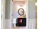 Stylish half bath with a modern vanity, oval mirror, and fresh, neutral décor at 912 Tanners Point Dr, Lawrenceville, GA 30044