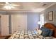 A well-lit bedroom features a large wooden bed with wood floors and neutral paint at 912 Tanners Point Dr, Lawrenceville, GA 30044