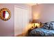 A cozy bedroom features warm, inviting decor, closet, and a sun-shaped mirror adding character at 912 Tanners Point Dr, Lawrenceville, GA 30044