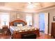 A well-lit bedroom features a large wooden bed with wood floors and neutral paint at 912 Tanners Point Dr, Lawrenceville, GA 30044