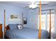 A primary bedroom features a four poster bed, ceiling fan, and lots of natural light at 912 Tanners Point Dr, Lawrenceville, GA 30044