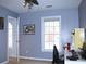Bedroom painted with calming blue, bright window, and a dedicated workspace at 912 Tanners Point Dr, Lawrenceville, GA 30044