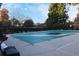Community pool covered with a green safety cover with chairs nearby at 912 Tanners Point Dr, Lawrenceville, GA 30044