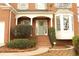 Welcoming front porch with brick steps, complemented by lush greenery and a colorful wreath at 912 Tanners Point Dr, Lawrenceville, GA 30044