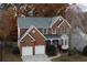 Beautiful two-story brick home with a well-manicured front yard and attached two-car garage at 912 Tanners Point Dr, Lawrenceville, GA 30044