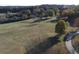 Expansive green field with mature trees, a walking path, and distant pond or lake views offers a tranquil natural setting at 912 Tanners Point Dr, Lawrenceville, GA 30044