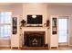 Cozy living room featuring a brick fireplace, built-in shelving, and comfortable seating arrangements at 912 Tanners Point Dr, Lawrenceville, GA 30044