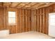 Unfinished garage features a window, white door, and exposed wooden frame, ready for customization at 912 Tanners Point Dr, Lawrenceville, GA 30044