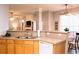 Open concept kitchen with stainless steel appliances and breakfast bar seating at 912 Tanners Point Dr, Lawrenceville, GA 30044