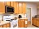 Kitchen view with white stove, light colored cabinets, and stainless steel microwave at 912 Tanners Point Dr, Lawrenceville, GA 30044
